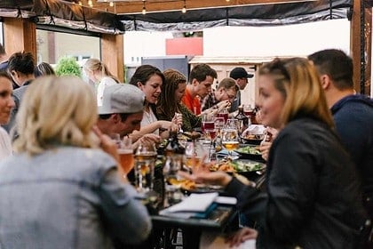 Friends enjoying a cozy dinner party outdoors.