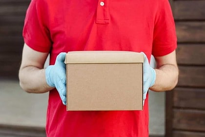 Person delivering parcel in Canada.