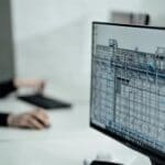 Person researching Canadian architecture programs on computer.