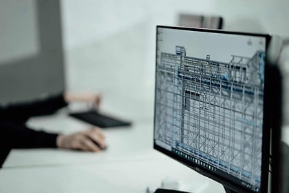 Person researching Canadian architecture programs on computer.