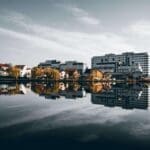 City skyline reflected in calm waterfront at dusk