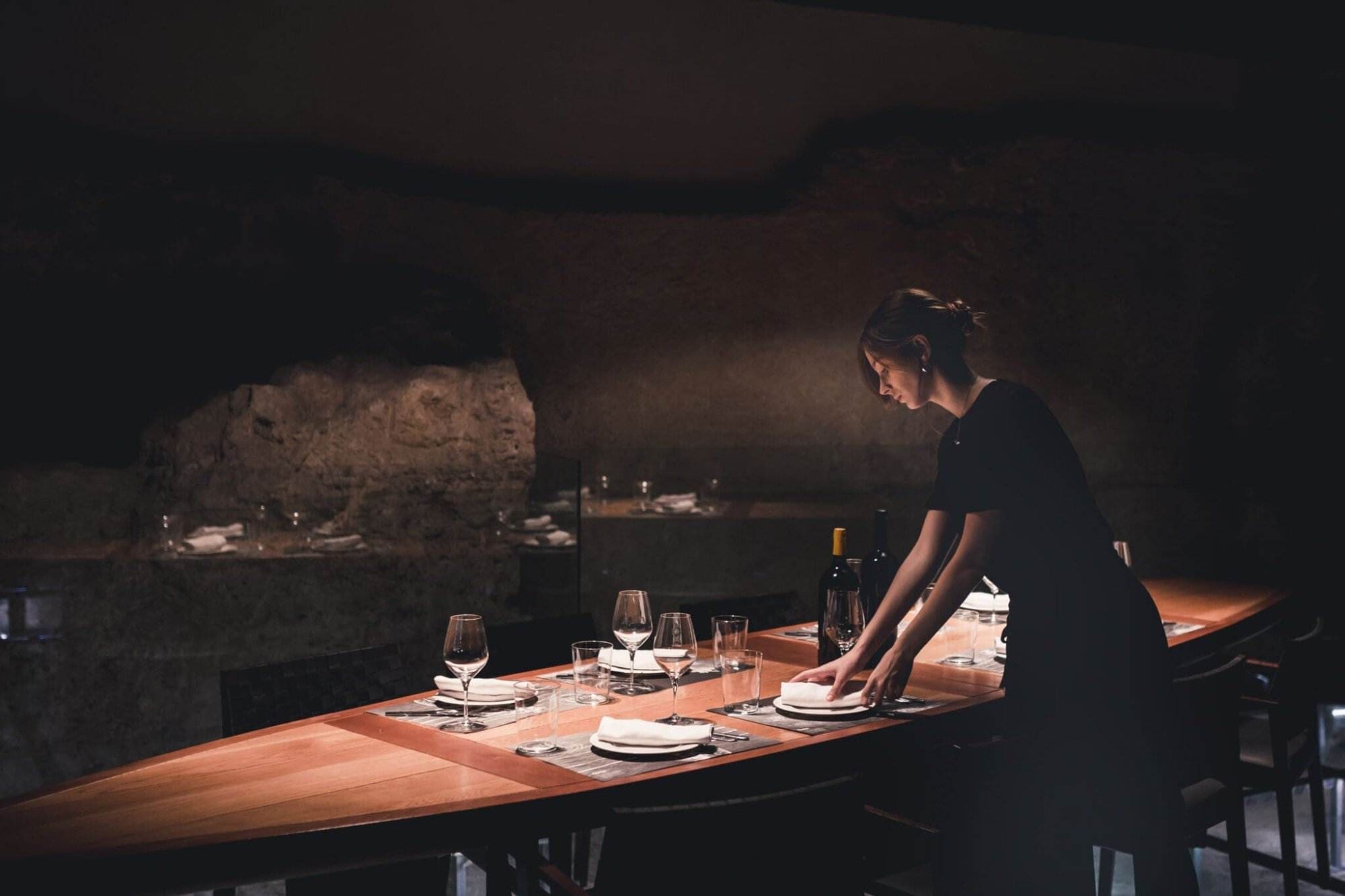 young waitress setting table