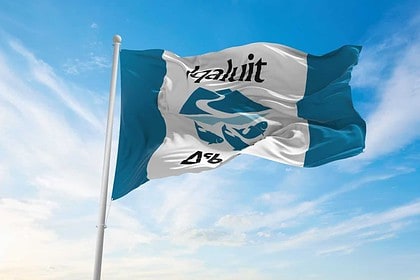 Iqaluit flag waving against a clear blue sky