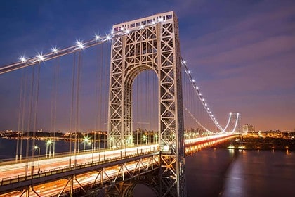 George Washington Bridge illuminated at night in New York City.