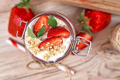 Fresh strawberry quinoa smoothie garnished with mint.