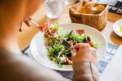 Person dining at a cozy Canmore restaurant.