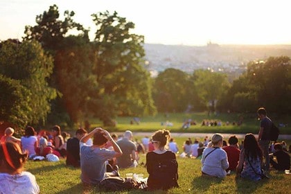 People enjoying sunset in a city park.