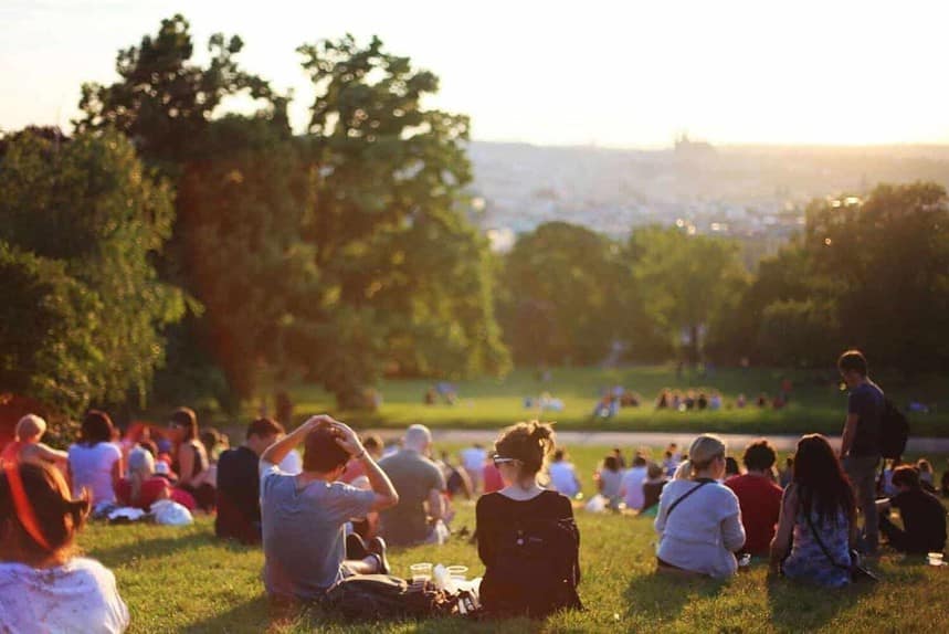 People enjoying sunset in a city park.