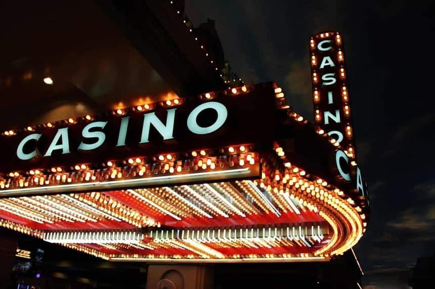 Illuminated neon casino sign at night.