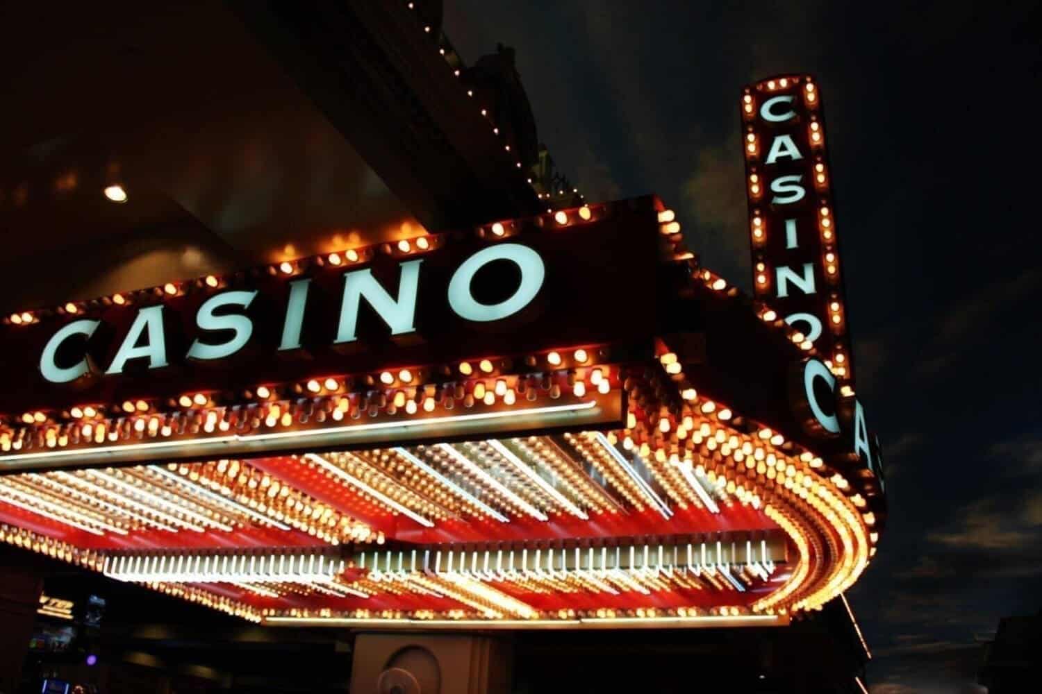 Illuminated neon casino sign at night.