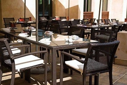 Elegant outdoor patio dining area with set tables.