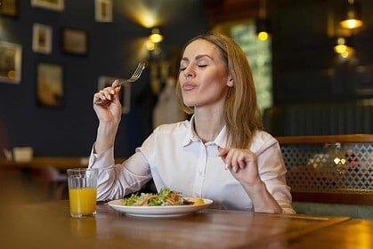 Woman savoring a meal at a cozy restaurant