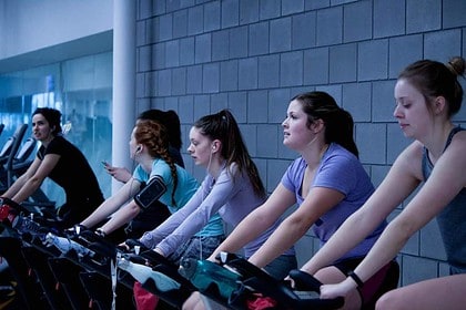 Indoor group cycling class in Brampton fitness center.