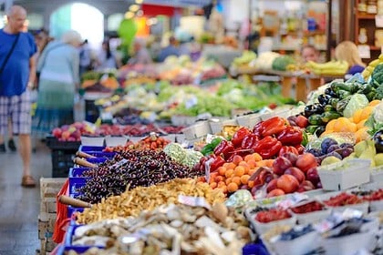 Vibrant farmers market with fresh produce and shoppers.