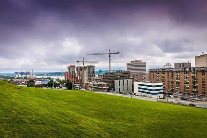 Halifax skyline with green hills under cloudy skies.