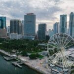 Aerial view of Miami skyline and Ferris wheel by the waterfront.