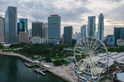 Aerial view of Miami skyline and Ferris wheel by the waterfront.