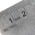 Close-up of a metric stainless steel ruler showing millimeter markings.