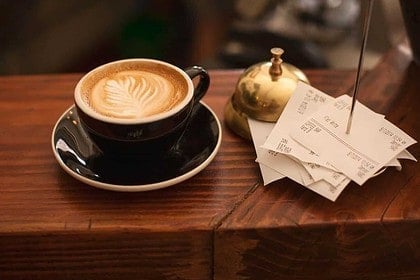 Latte with artful foam in a cozy Vancouver cafe setting.