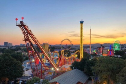 Idaho amusement park at sunset with lights and rides.