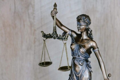 Statue of Lady Justice holding scales, symbolizing law and fairness.