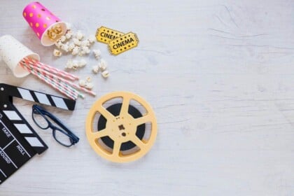 Home movie night essentials with popcorn and film reel.