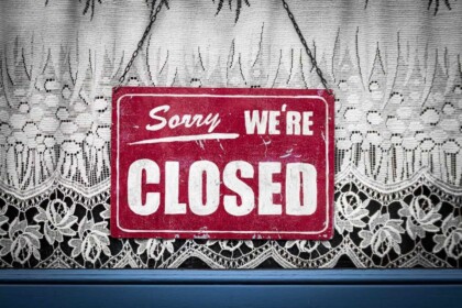 Vintage closed sign on store window in Montreal.