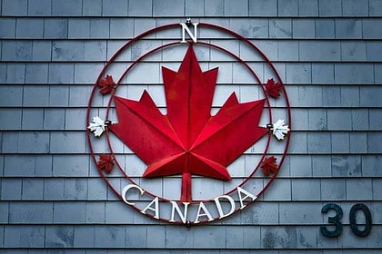 Canadian maple leaf emblem on building facade.
