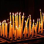 Lit candles in a dark ambiance for prayer or vigil.