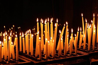 Lit candles in a dark ambiance for prayer or vigil.