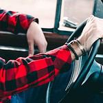 Person holding steering wheel during driving lesson