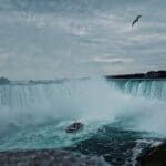Misty Niagara Falls with Tour Boat and Flying Bird