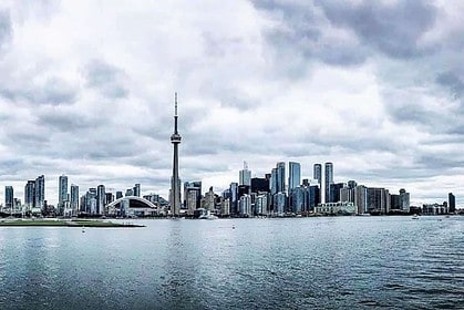 Toronto skyline with CN Tower over waterfront.