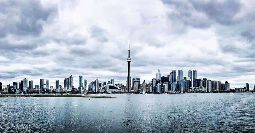 Toronto skyline with CN Tower over waterfront.