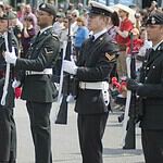 Uniformed soldiers standing in formation during a military parade.