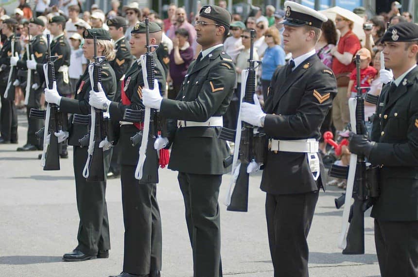Uniformed soldiers standing in formation during a military parade.