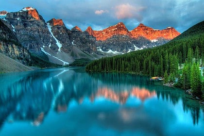 Sunrise at Moraine Lake with mountain reflections in Alberta.