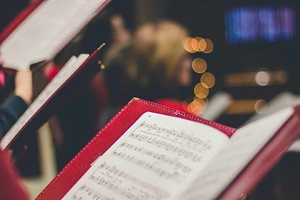 Candlelit sheet music during a festive concert event.