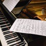 Grand piano with sheet music, evoking classical music elegance.