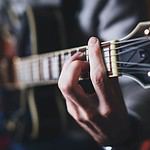 Guitarist playing at a candlelit tribute event in Toronto.
