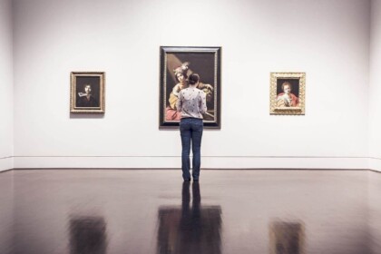 Art enthusiast admiring paintings at Mississauga gallery exhibit.