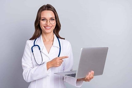 Smiling pharmacist with laptop promoting online pharmacy services.