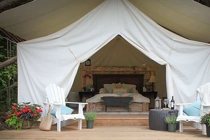 Elegant Glamping Tent with Plush Bedding and Outdoor Seating