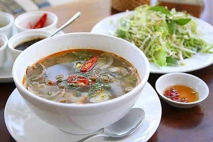 Authentic Asian pho soup with fresh herbs and beef.