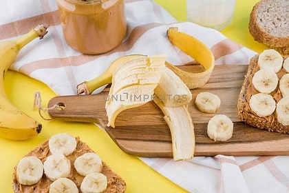 Banana peanut butter toast preparation.