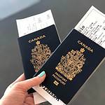 Canadian passports and boarding passes held in hand.
