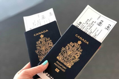 Canadian passports and boarding passes held in hand.