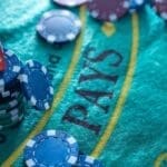 Colorful casino chips stacked on a gaming table.