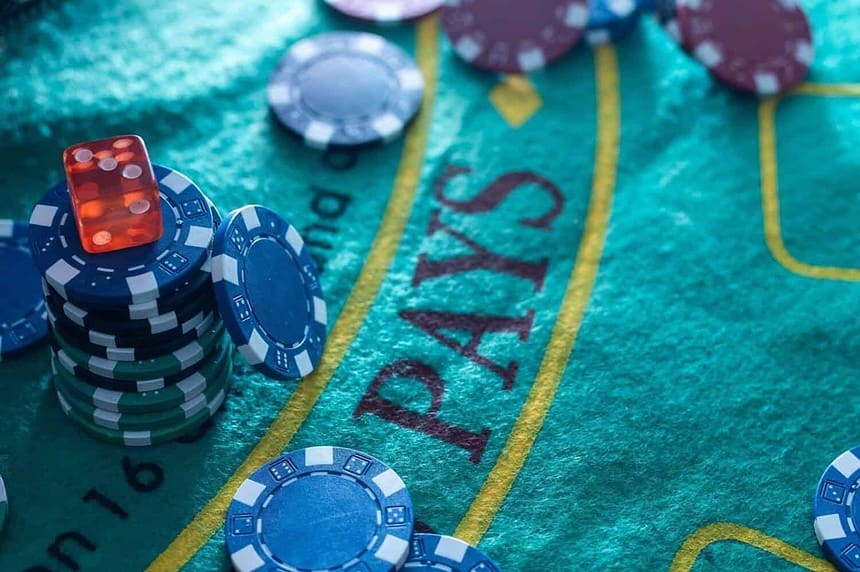 Colorful casino chips stacked on a gaming table.