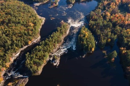 Aerial view of Ottawa river rapids in autumn foliage.